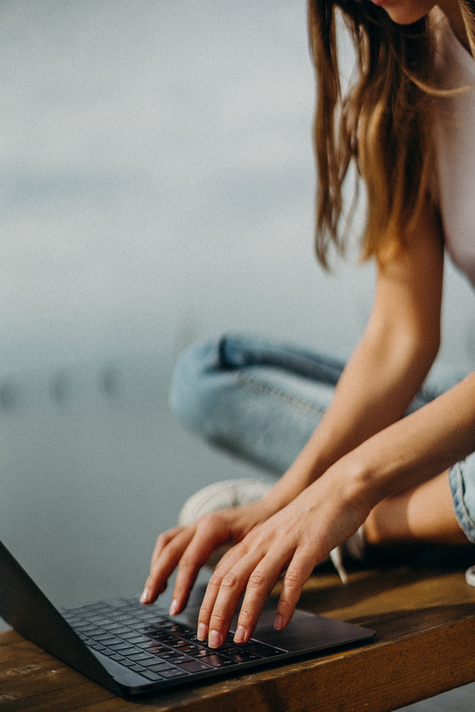 girl typing on laptop